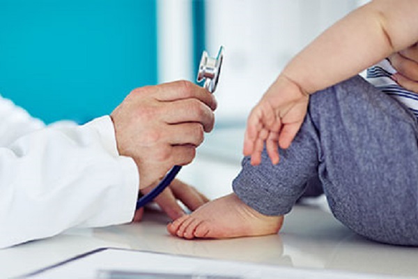 Doctor showing a stethoscope to a small child